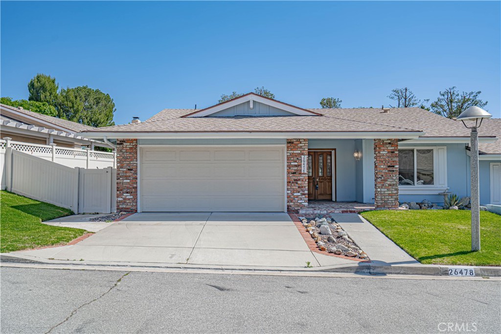 26478 Fairway Circle Newhall, CA 91321 - Photo 33 of 60 a front view of a house with a yard and garage