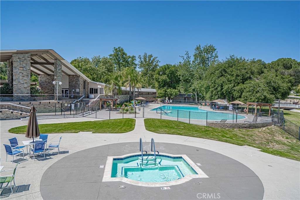 26478 Fairway Circle Newhall, CA 91321 - Photo 41 of 60 a swimming pool with outdoor seating and yard