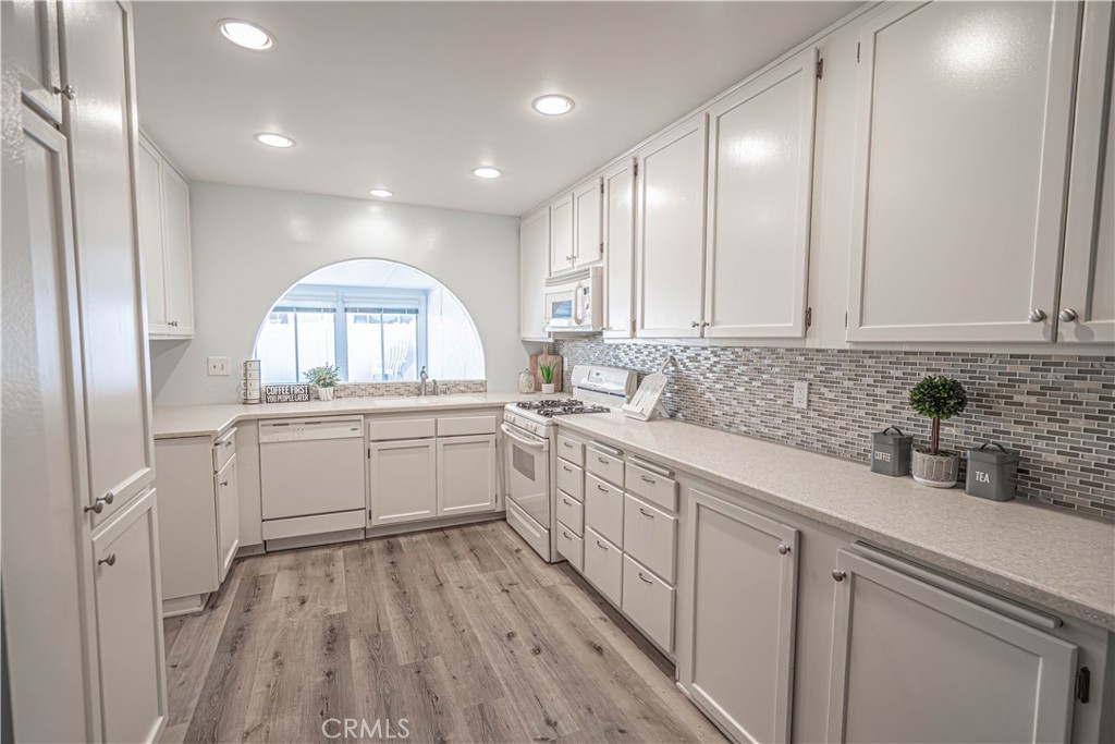 26478 Fairway Circle Newhall, CA 91321 - Photo 8 of 60 a kitchen with white cabinets and sink