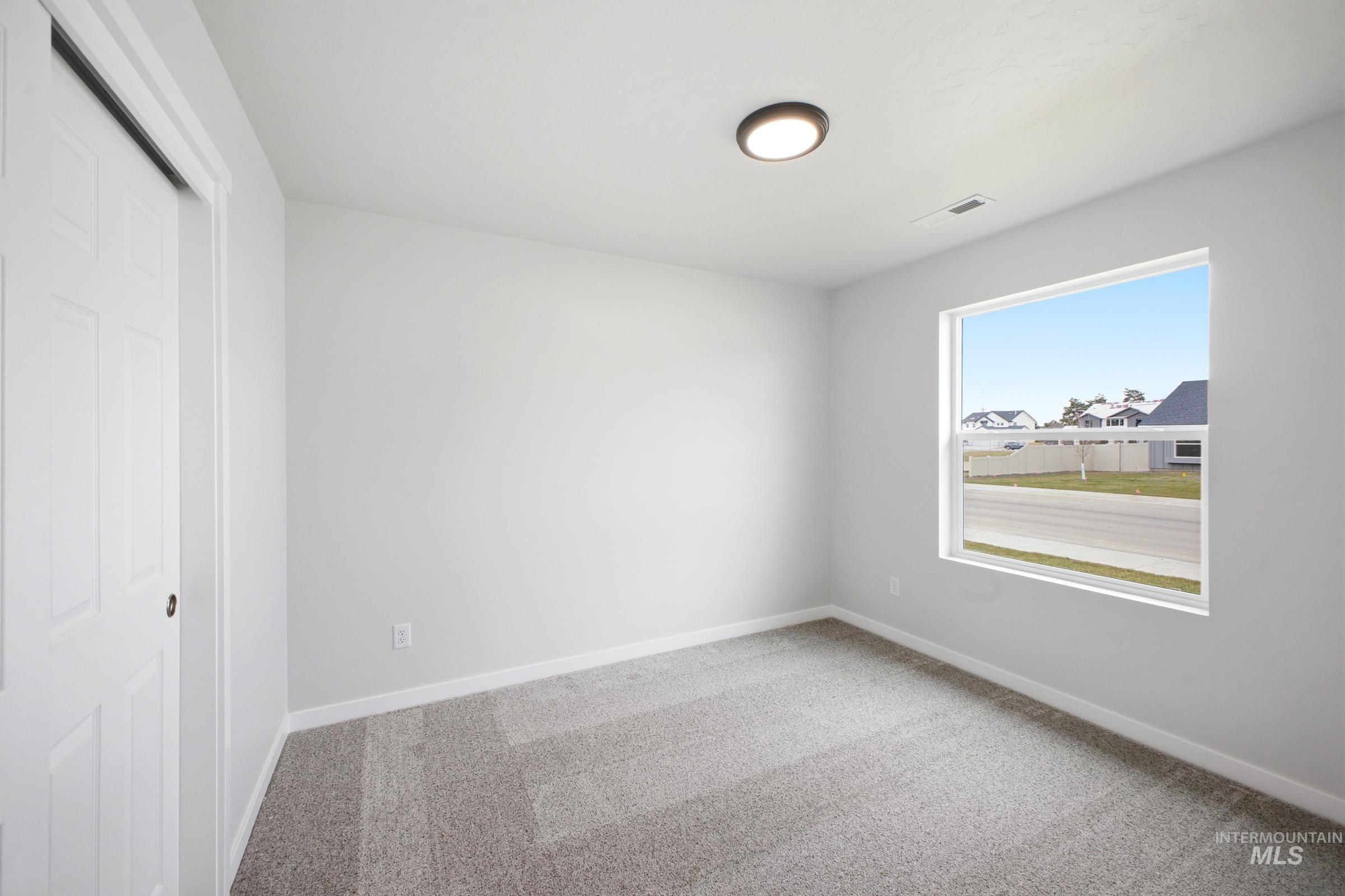 1598 Sunday River Street Middleton, ID 83644 - Photo 10 of 17 Interior room with light gray walls and plush gray carpet flooring