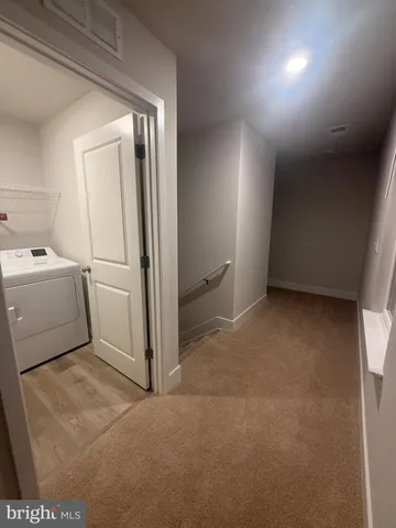 a view of a room with wooden floor and staircase