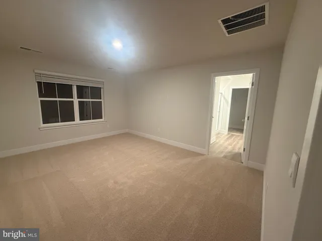 a view of a hallway with wooden floor and entryway