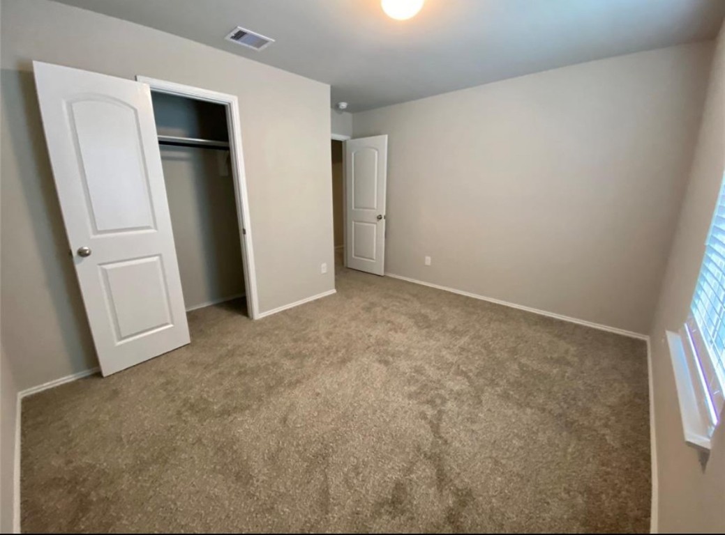2330 Georgina Falls Drive Spring, TX 77373 - Photo 9 of 12 an empty room with closet and mirror