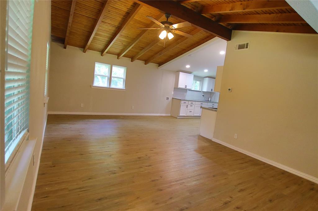 142 Andrea Street, Unit B Pottsboro, TX 75076 - Photo 1 of 22 a view of empty room with wooden floor and fan