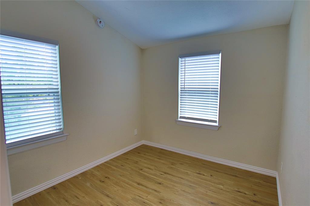 142 Andrea Street, Unit B Pottsboro, TX 75076 - Photo 13 of 22 an empty room with a window