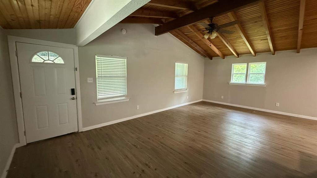 142 Andrea Street, Unit B Pottsboro, TX 75076 - Photo 2 of 22 an empty room with wooden floor and windows