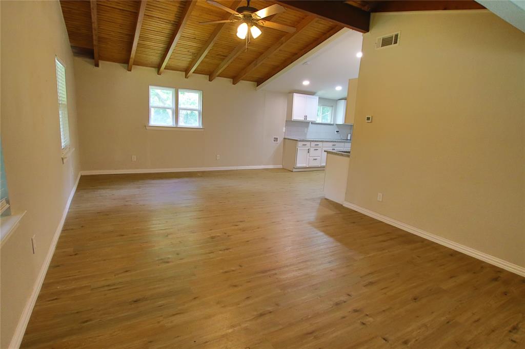 142 Andrea Street, Unit B Pottsboro, TX 75076 - Photo 3 of 22 a view of empty room with wooden floor and fan