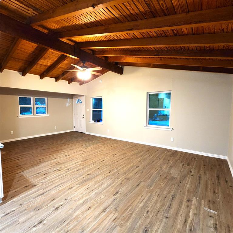 142 Andrea Street, Unit B Pottsboro, TX 75076 - Photo 4 of 22 a view of an empty room with wooden floor and a window
