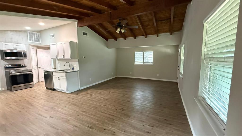 142 Andrea Street, Unit B Pottsboro, TX 75076 - Photo 5 of 22 a view of a kitchen with a sink oven window and wooden floor