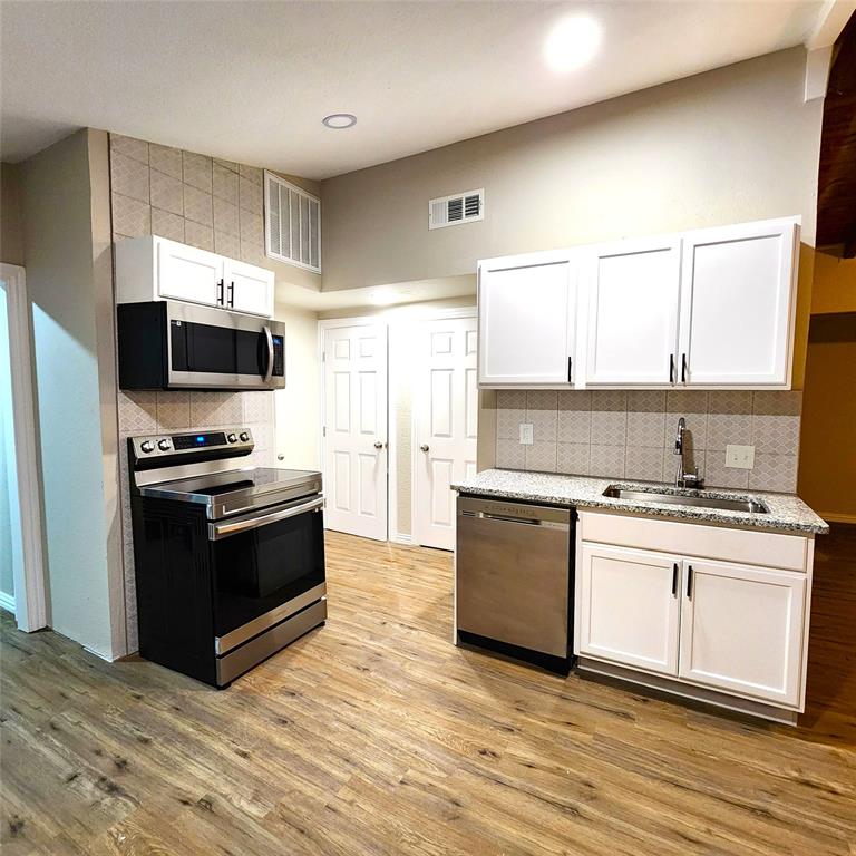 142 Andrea Street, Unit B Pottsboro, TX 75076 - Photo 8 of 22 a kitchen with granite countertop a stove and a refrigerator
