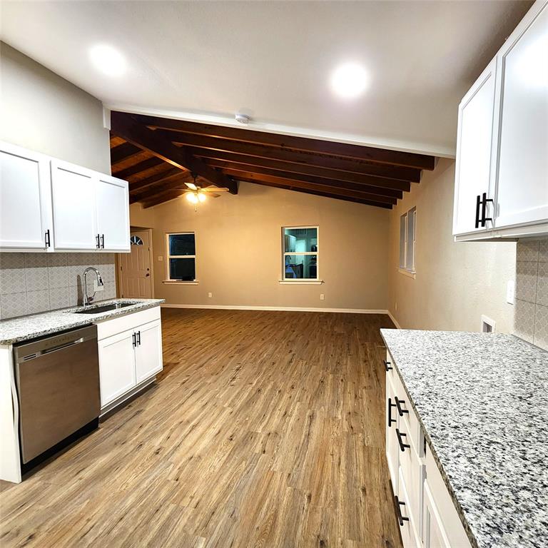 142 Andrea Street, Unit B Pottsboro, TX 75076 - Photo 9 of 22 a kitchen with wooden floors and white appliances