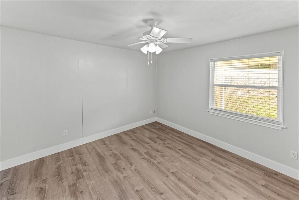 334 County Road 1296 Morgan, TX 76671 - Photo 11 of 32 wooden floor in an empty room with a window