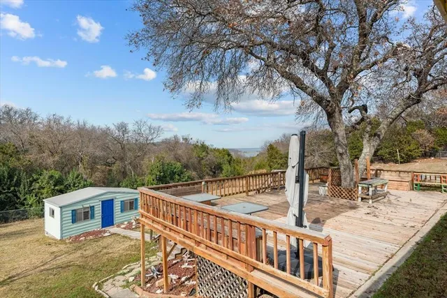 a view of a wooden chairs and a table on the deck