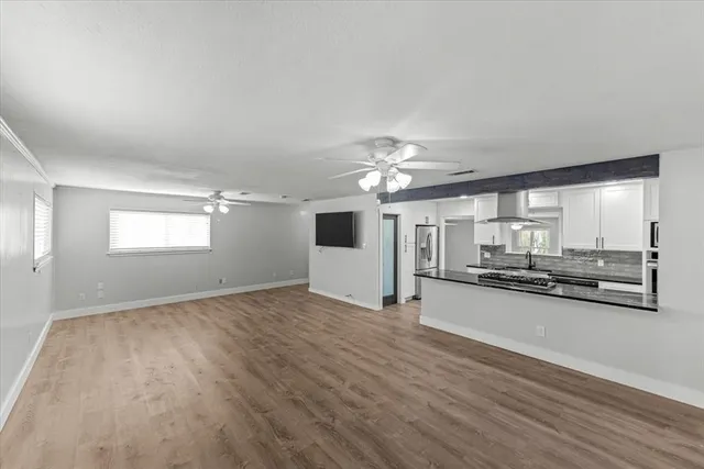 a view of a kitchen with a sink and microwave