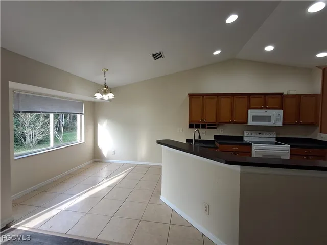 a kitchen with stainless steel appliances granite countertop a sink and a stove