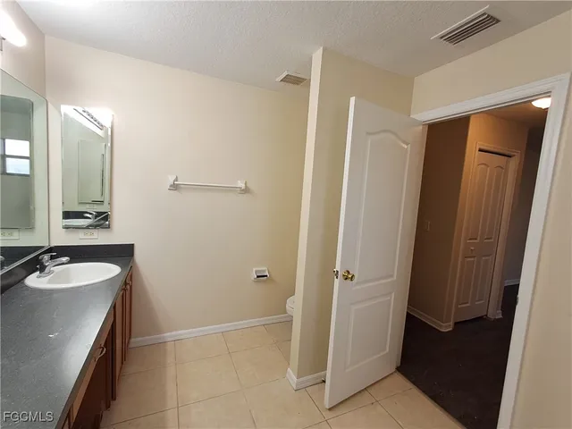 a bathroom with a sink a toilet a mirror and shower