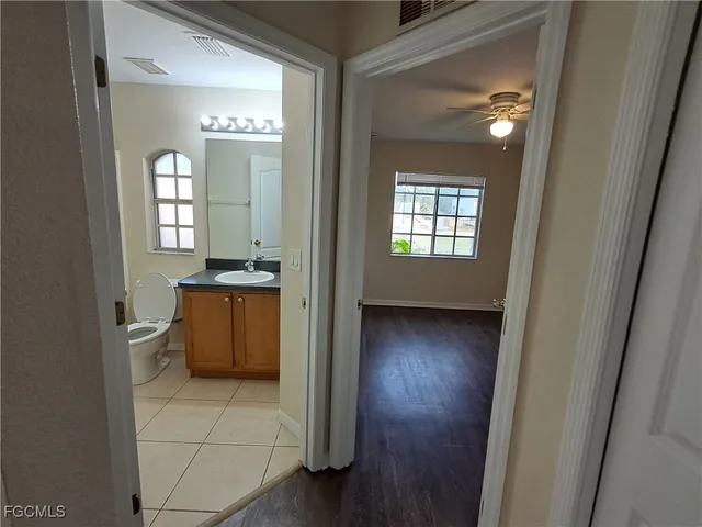 a view of a hallway and a livingroom with a window