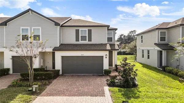 a front view of a house with a yard and garage