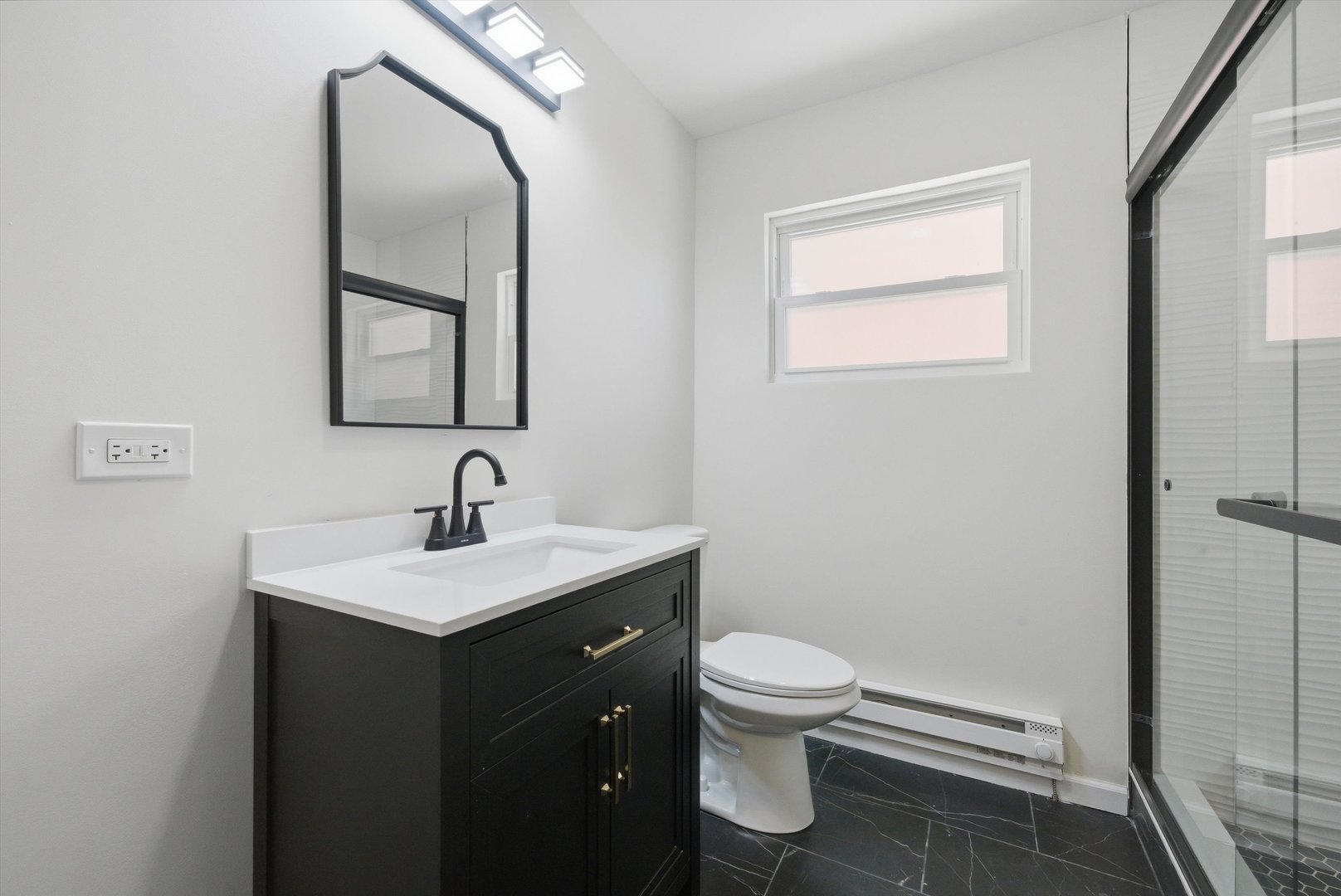 3907 West Marquette Road Chicago, IL 60629 - Photo 7 of 32 a bathroom with a toilet a sink and mirror