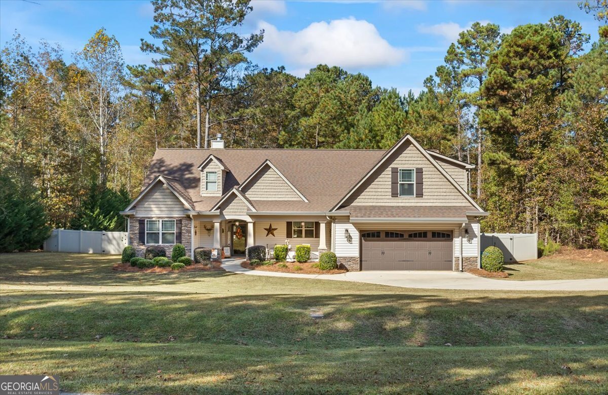 a front view of a house with a yard table and chairs
