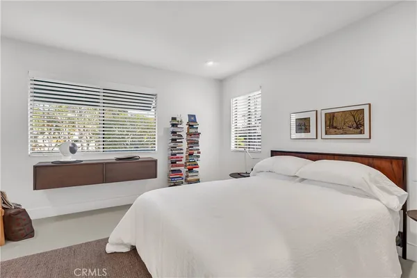 a bedroom with a large bed and a large window