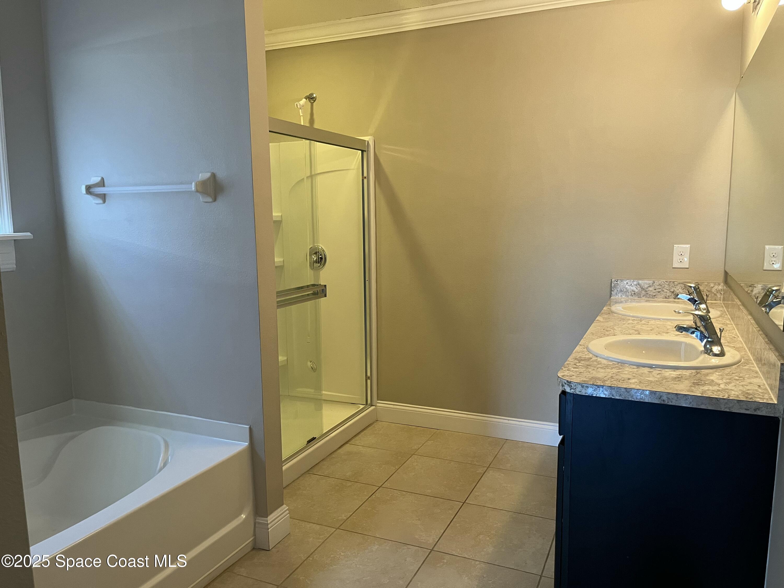 2209 McCormack Way Melbourne, FL 32935 - Photo 12 of 22 a bathroom with a granite countertop sink and a bathtub