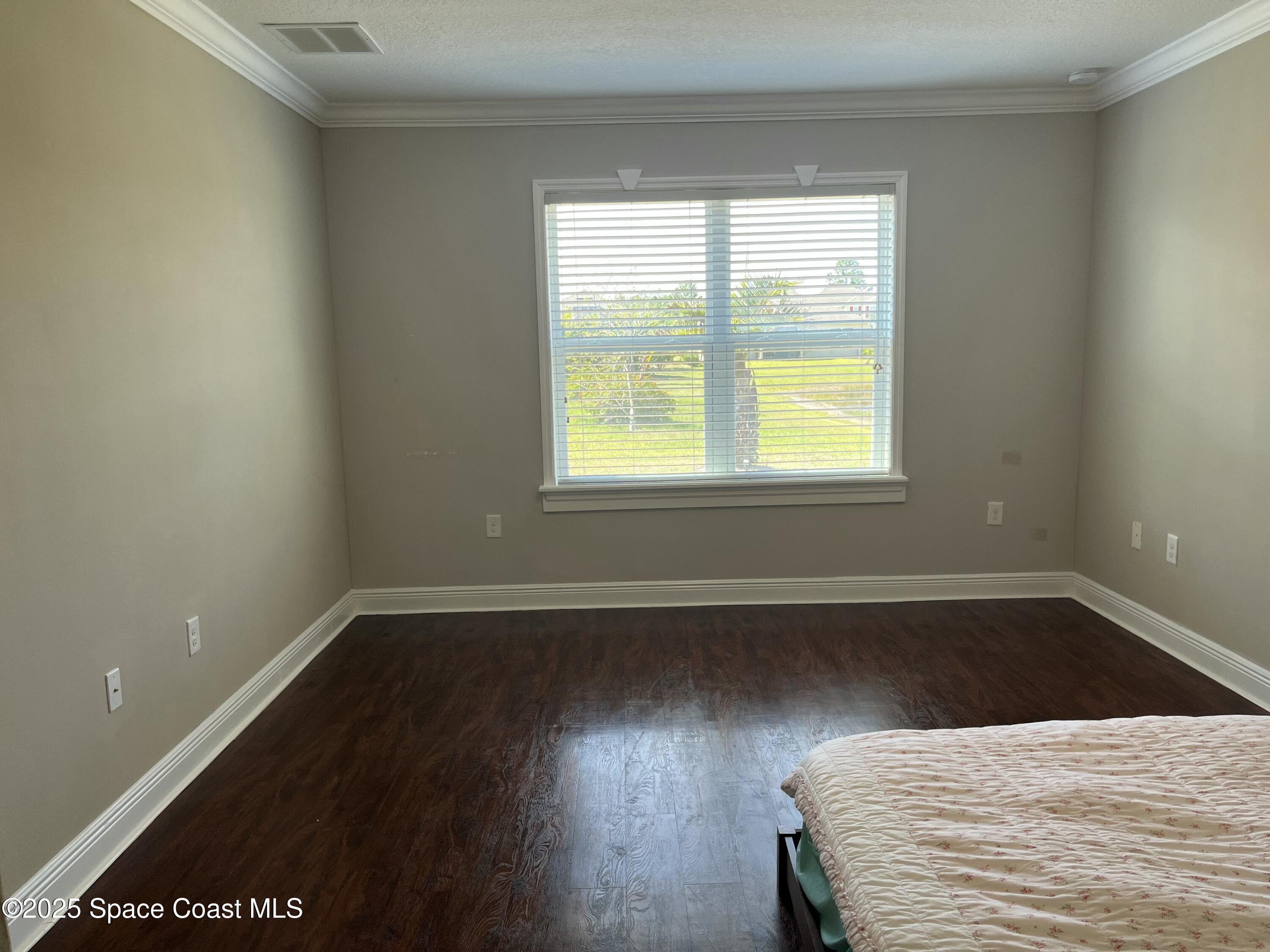 2209 McCormack Way Melbourne, FL 32935 - Photo 15 of 22 a view of a room with wooden floor and a window