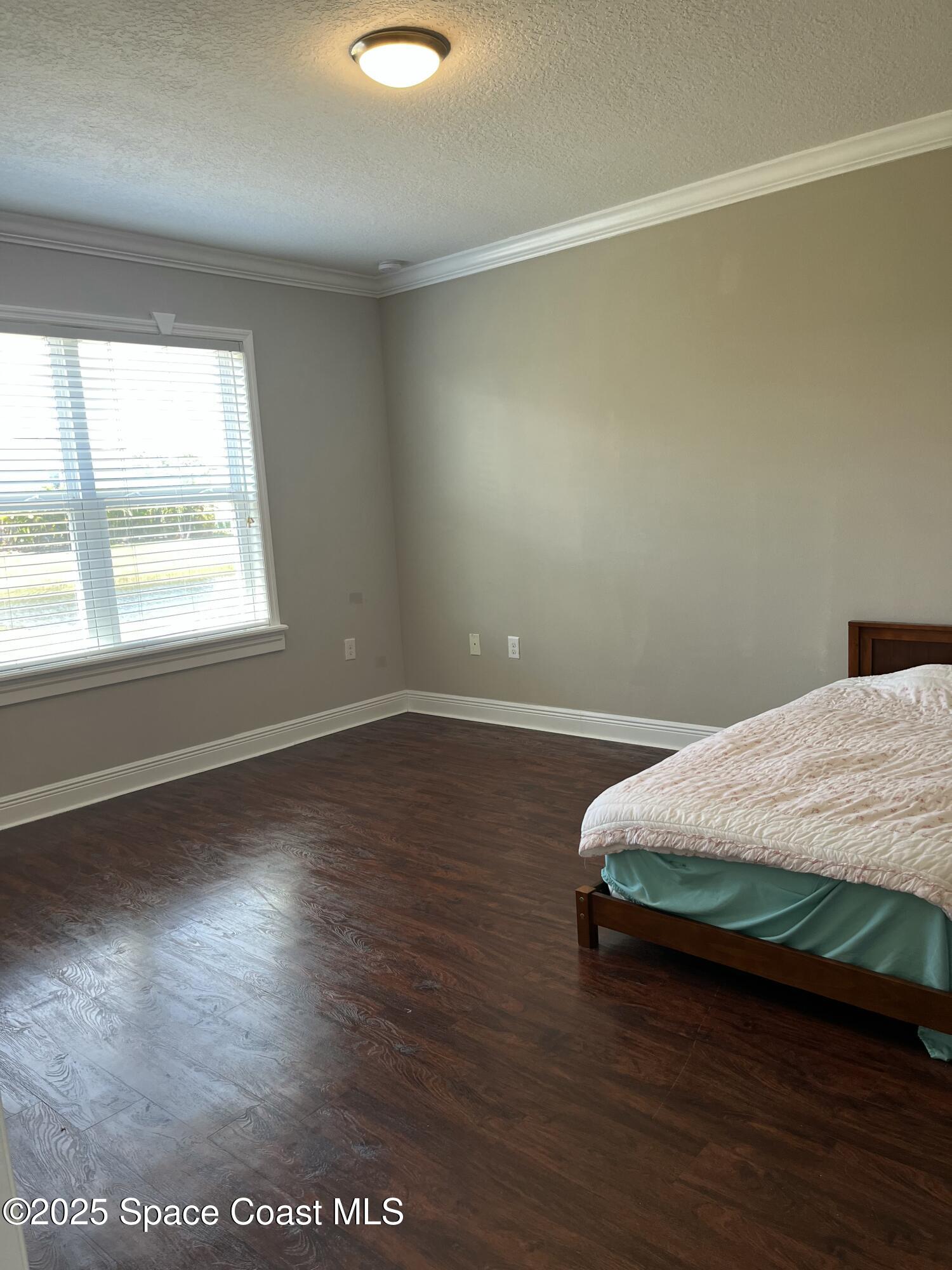 2209 McCormack Way Melbourne, FL 32935 - Photo 16 of 22 a bedroom with a bed and window