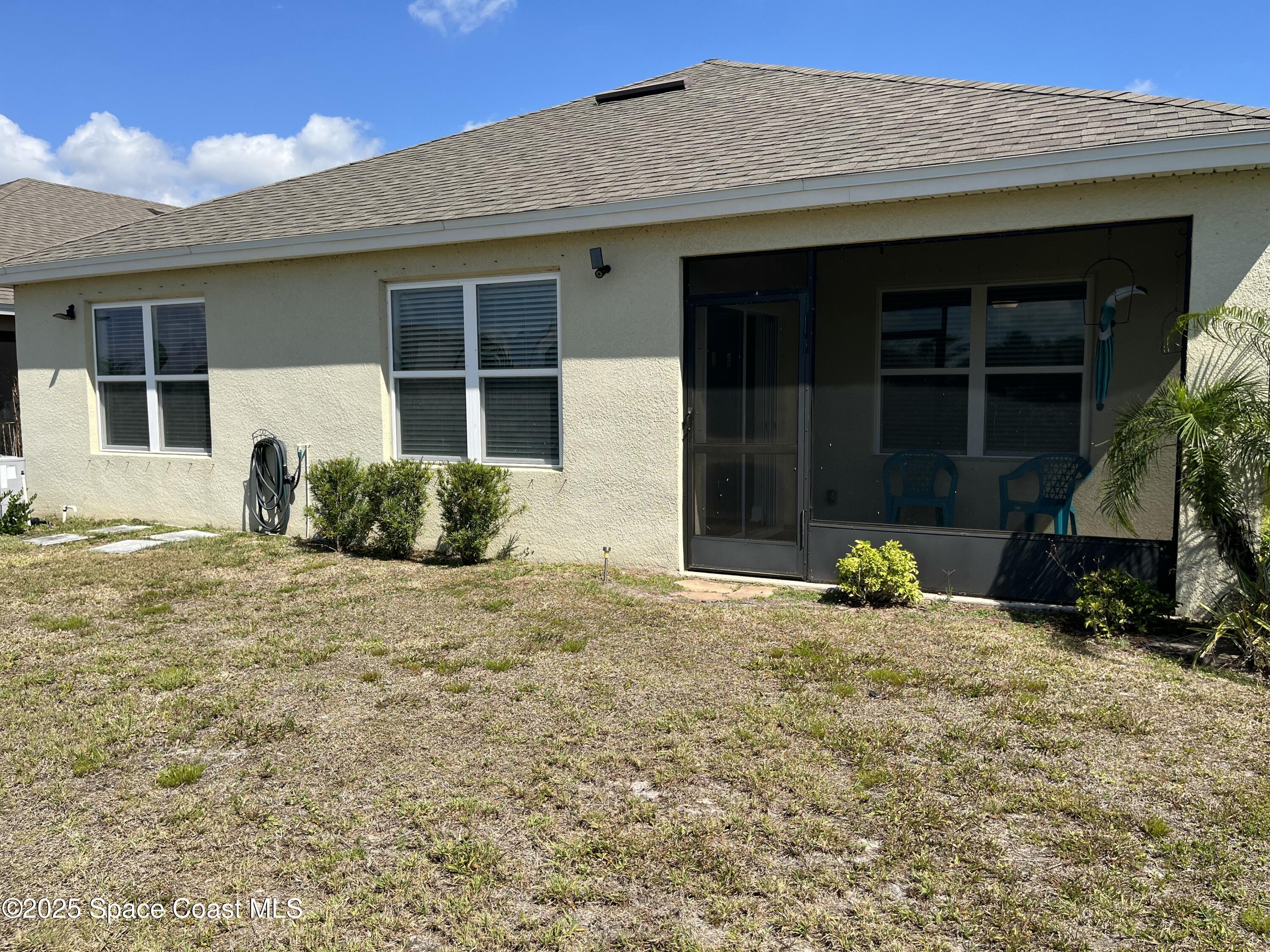 2209 McCormack Way Melbourne, FL 32935 - Photo 18 of 22 a front view of a house with a yard