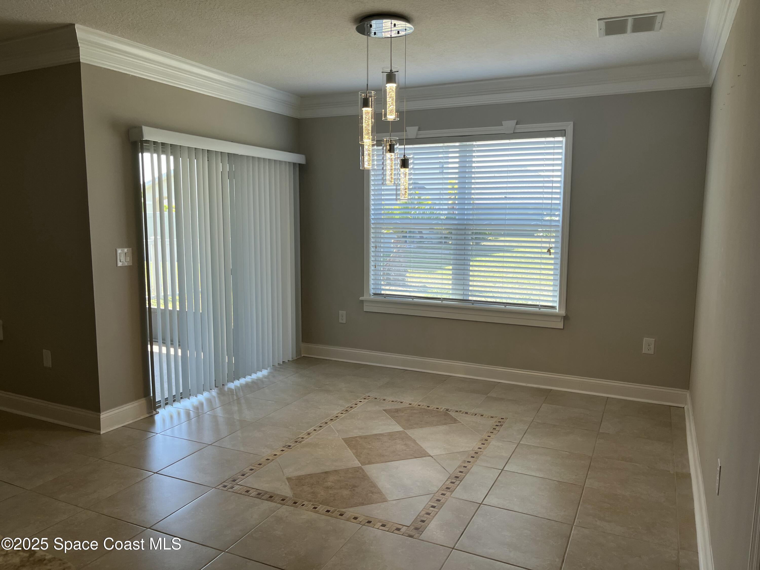 2209 McCormack Way Melbourne, FL 32935 - Photo 8 of 22 a view of an empty room with a window
