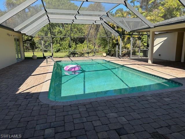 1261 Pine Ridge Road Naples, FL 34108 - Photo 3 of 13 Swimming pool featuring a patio, a lanai, and a sunroom