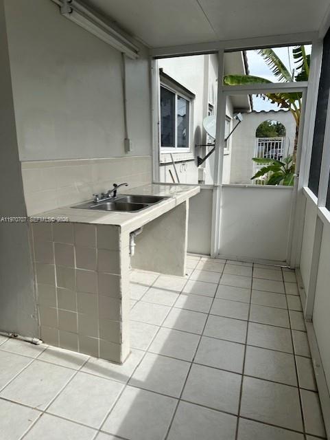 312 Southwest 76th Court, Unit 1 Miami, FL 33144 - Photo 16 of 18 a kitchen with a sink a stove and cabinets