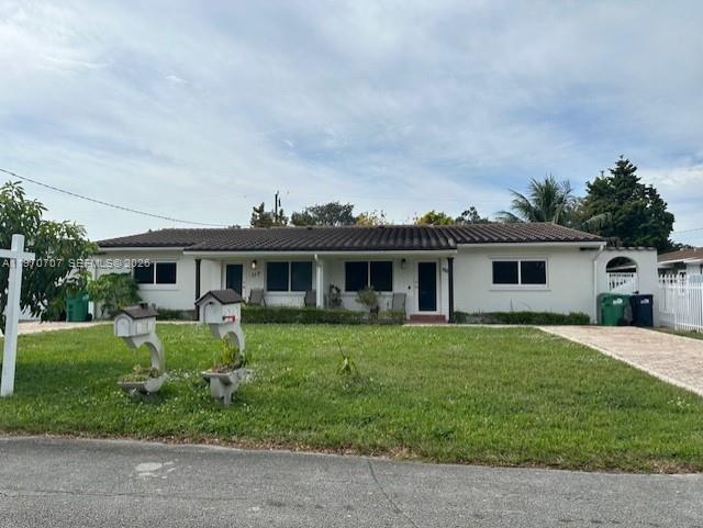 312 Southwest 76th Court, Unit 1 Miami, FL 33144 - Photo 2 of 18 a front view of a house with a garden and trees