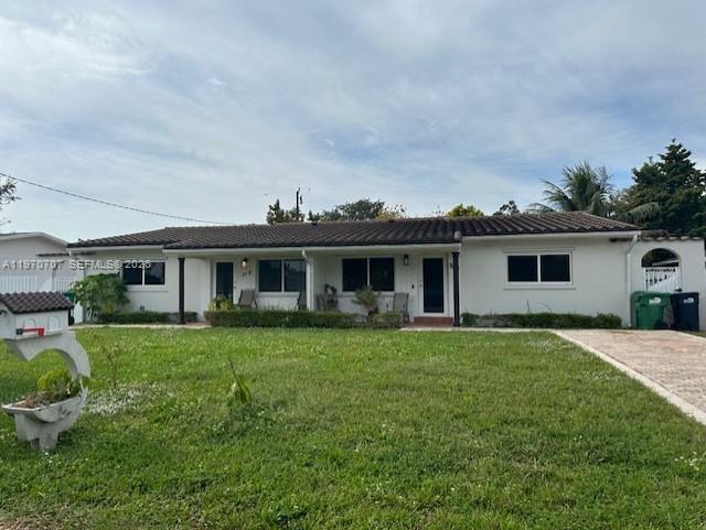 312 Southwest 76th Court, Unit 1 Miami, FL 33144 - Photo 3 of 18 a front view of a house with a garden