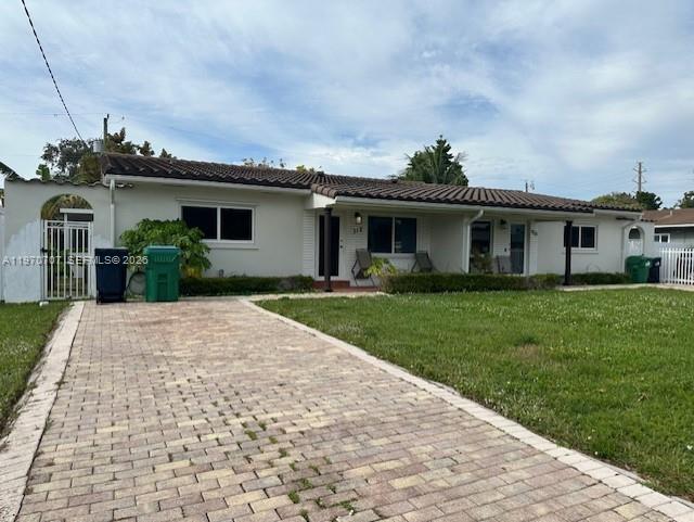 312 Southwest 76th Court, Unit 1 Miami, FL 33144 - Photo 4 of 18 a front view of a house with garden