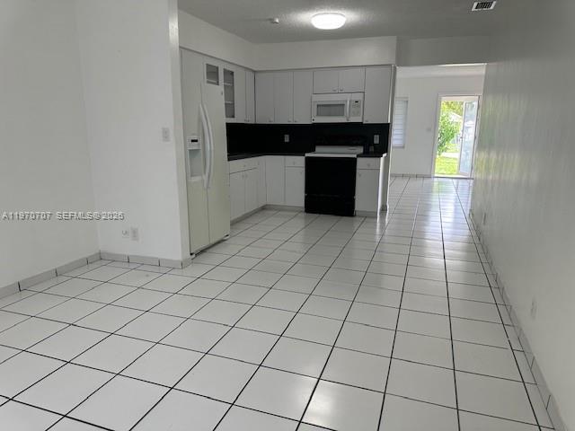 312 Southwest 76th Court, Unit 1 Miami, FL 33144 - Photo 6 of 18 a kitchen with stainless steel appliances a sink and cabinets