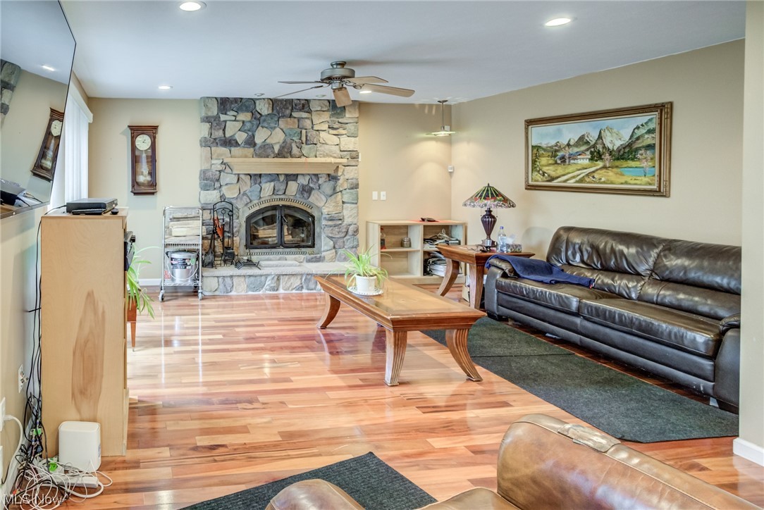 171 Nobottom Road Berea, OH 44017 - Photo 15 of 30 Living room with light hardwood / wood-style flooring, ceiling fan, and a stone fireplace