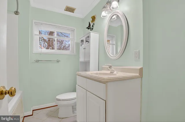a bathroom with a toilet a sink and a mirror