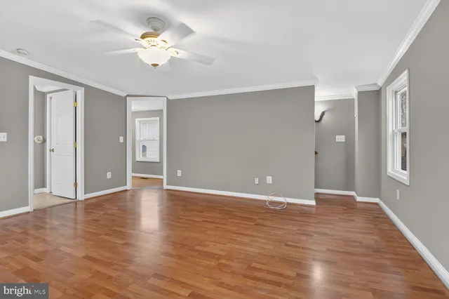 wooden floor in an empty room with a window
