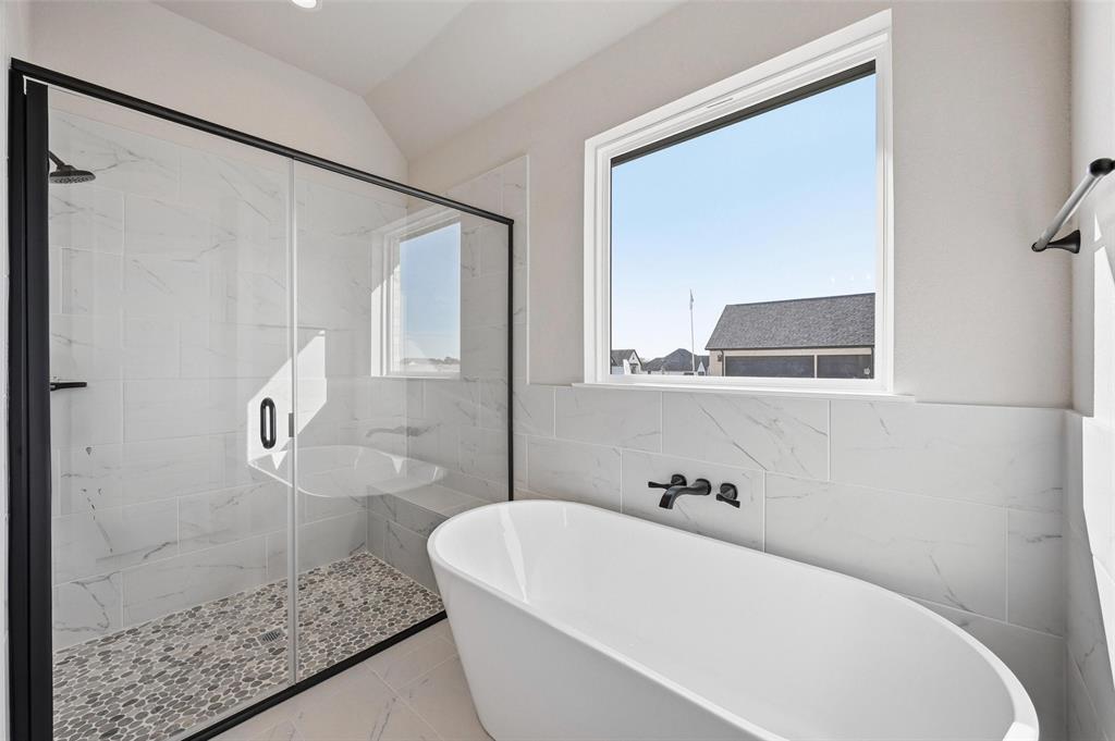 108 Rocky Top Azle, TX 76020 - Photo 17 of 40 a bathroom with a bathtub and a shower