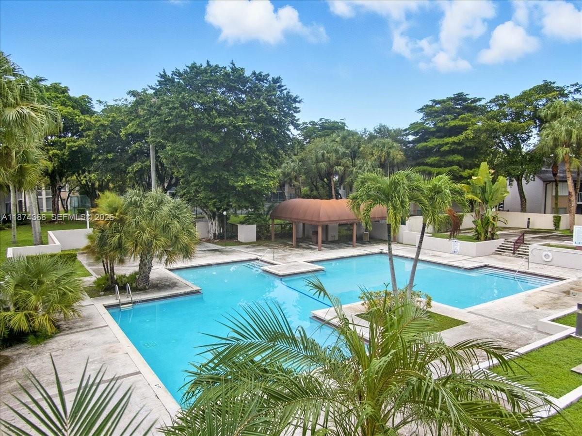9167 Southwest 138th Place, Unit 9167 Miami, FL 33186 - Photo 12 of 16 a view of a swimming pool with a patio