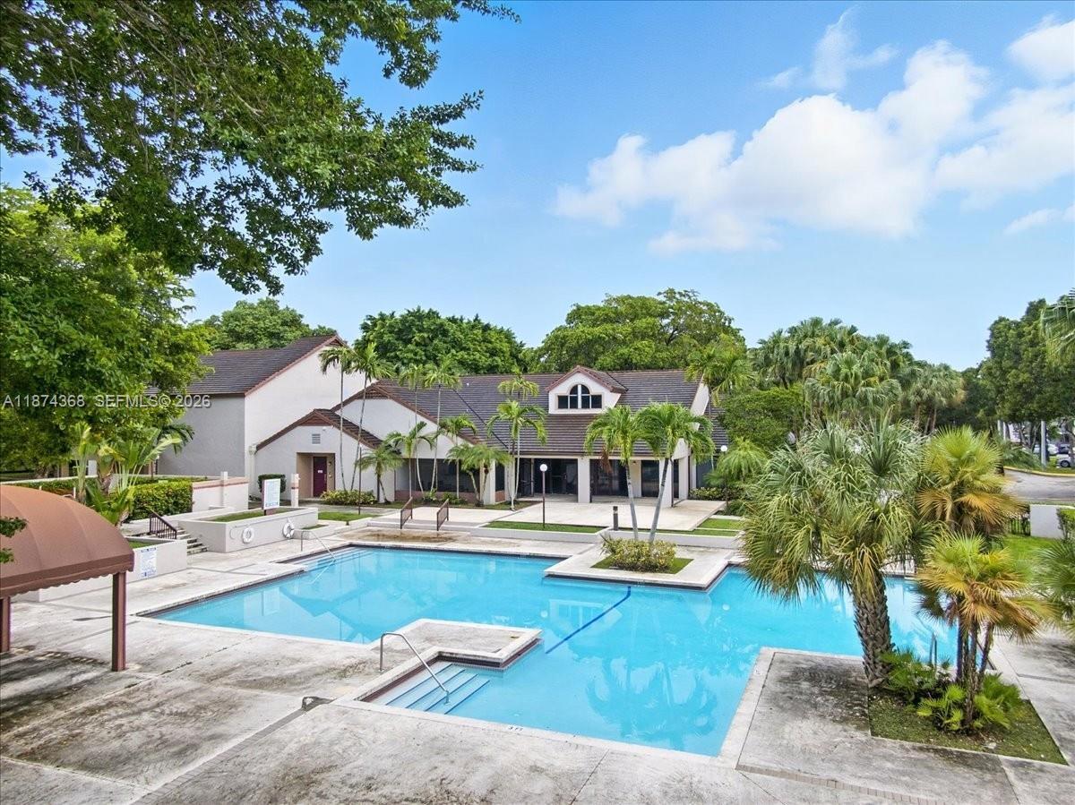 9167 Southwest 138th Place, Unit 9167 Miami, FL 33186 - Photo 13 of 16 a view of a house with swimming pool and sitting area