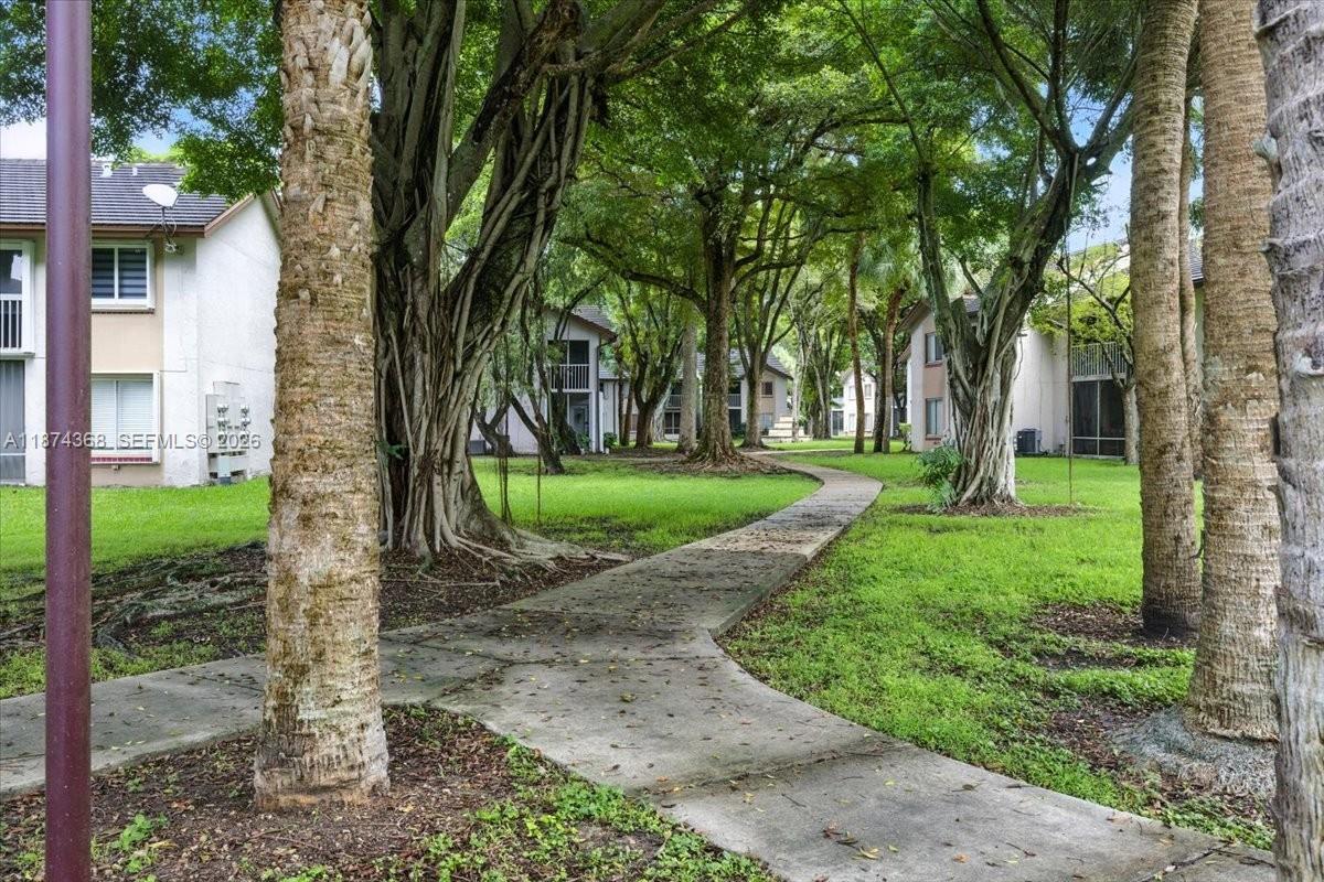 9167 Southwest 138th Place, Unit 9167 Miami, FL 33186 - Photo 14 of 16 a view of a house with a backyard
