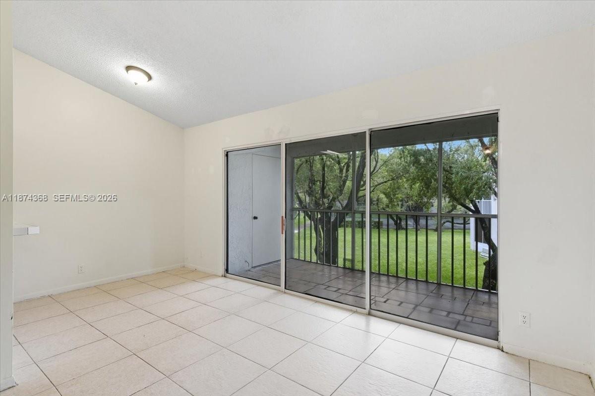 9167 Southwest 138th Place, Unit 9167 Miami, FL 33186 - Photo 3 of 16 a view of a room with sliding glass door and mountain view