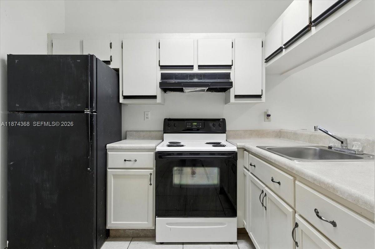 9167 Southwest 138th Place, Unit 9167 Miami, FL 33186 - Photo 4 of 16 a kitchen with stainless steel appliances granite countertop a stove a refrigerator and a sink