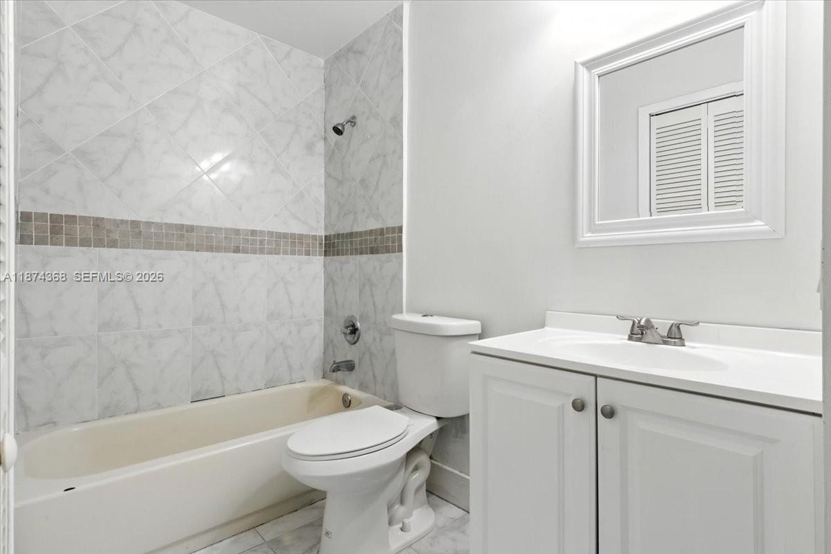 9167 Southwest 138th Place, Unit 9167 Miami, FL 33186 - Photo 7 of 16 a bathroom with a sink toilet and shower