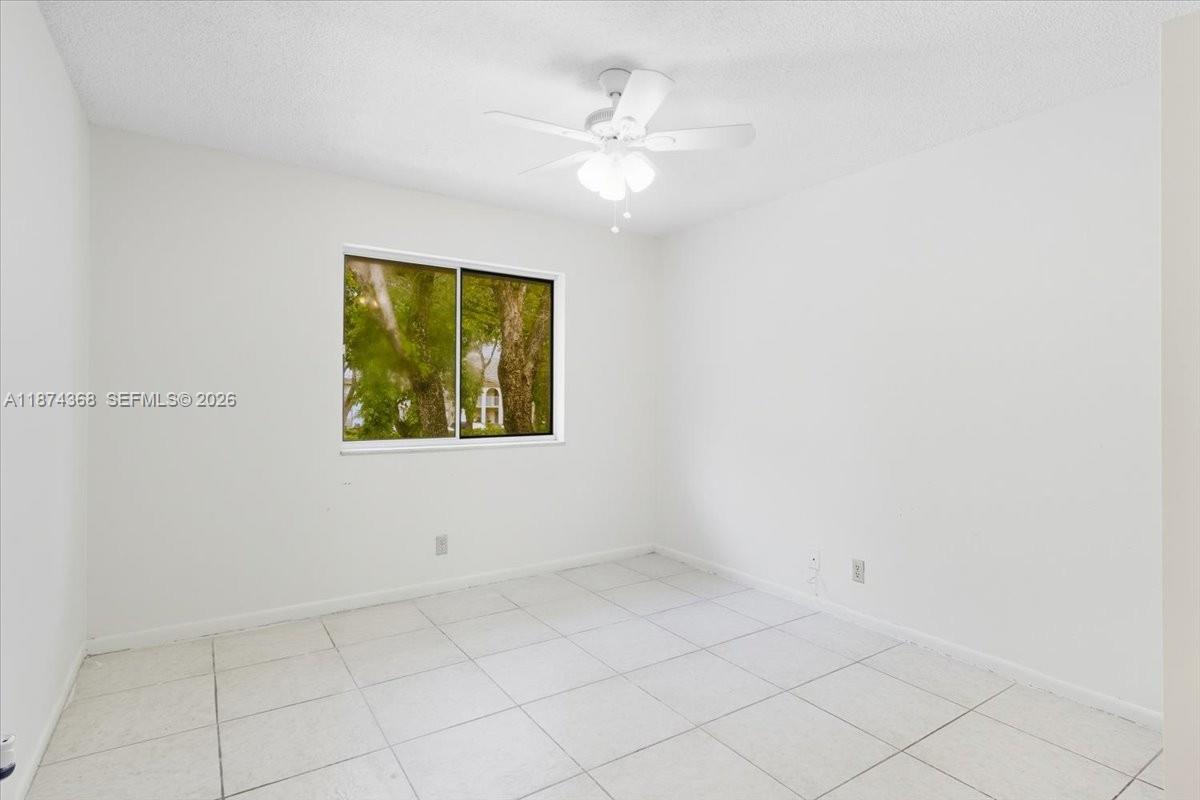 9167 Southwest 138th Place, Unit 9167 Miami, FL 33186 - Photo 9 of 16 an empty room with a window