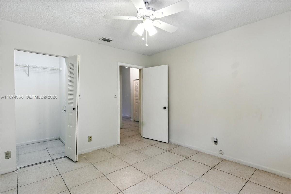 9167 Southwest 138th Place, Unit 9167 Miami, FL 33186 - Photo 10 of 16 wooden floor in an empty room