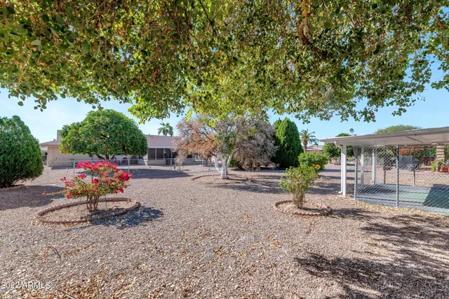 a view of a house with backyard and sitting area