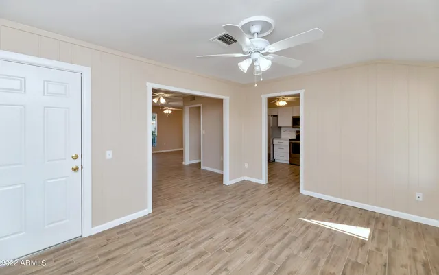a view of an empty room with wooden floor